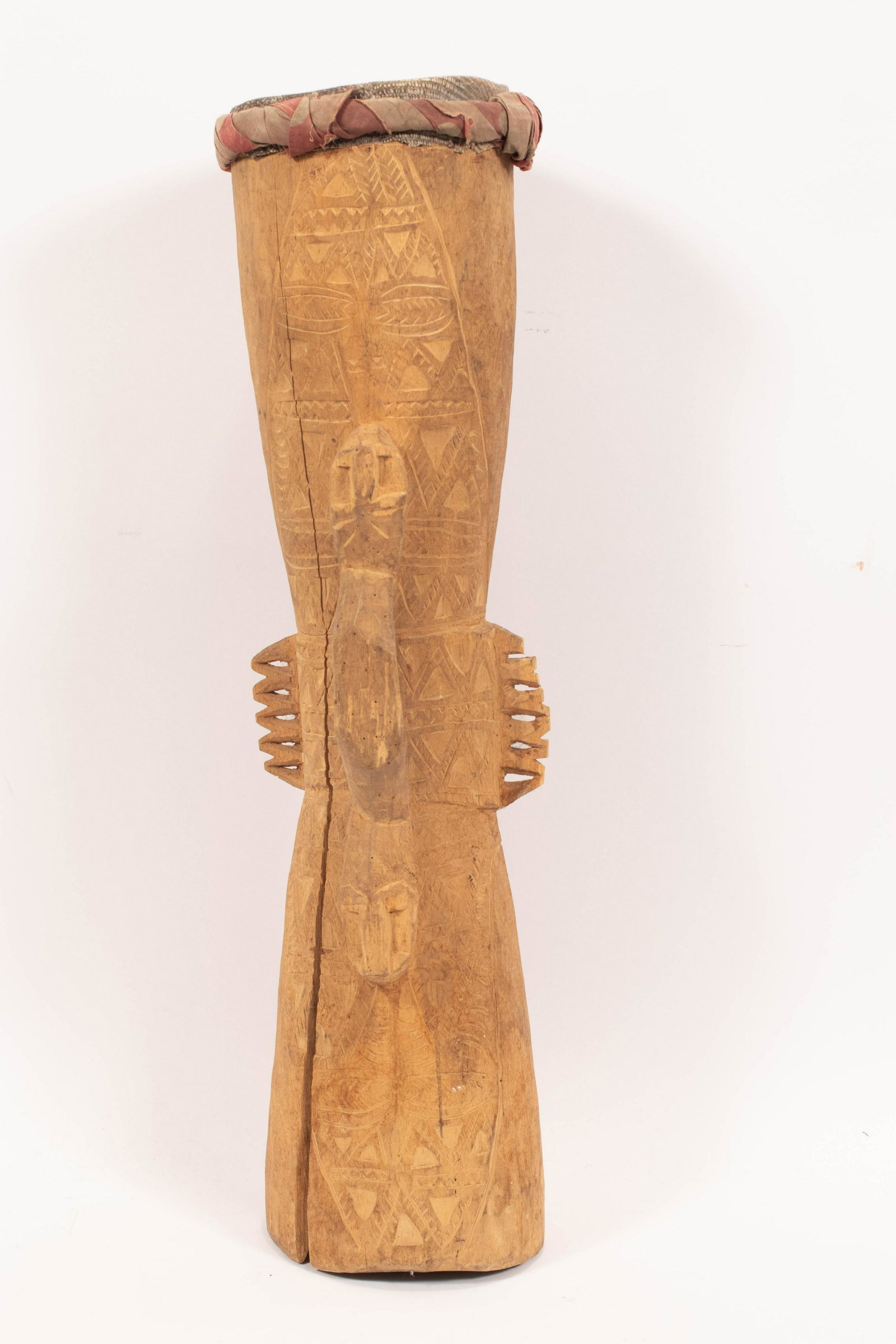 AFRICAN CARVED WOOD, CLOTH & LEATHER DRUM, H 23", DIA: AFRICAN CARVED WOOD, CLOTH & LEATHER DRUM, H 23", DIA 6" An African drum. Made of carved wood, cloth and leather top.