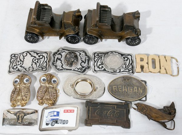 BELT BUCKLES, EISENHOWER, REAGAN, AUTO BANKS: BELT BUCKLES, EISENHOWER, REAGAN, SIGNED COCA-COLA, AUTO BANKS, 1960-'80, 17 PCS.:15 buckles and 2 banks; Reagan, Eisenhower 1972, $1dollar coin, Fish shape signed 2-145, Berga Metal works,1979, engra