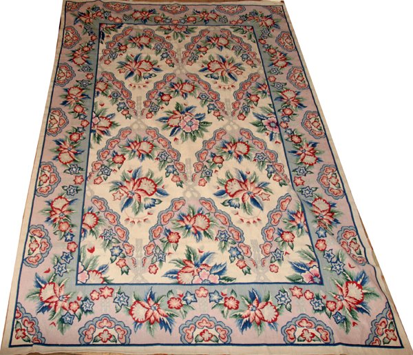 NEEDLEPOINT WOOL RUG, 8' 5" X 5' 6": NEEDLEPOINT WOOL RUG, 8' 5" X 5' 6":Ivory field with red, blue and green bold flowers; single wide border.