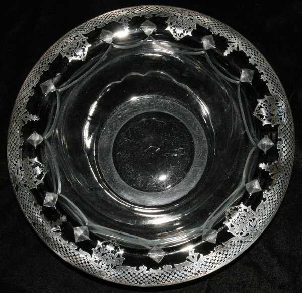 CRYSTAL AND SILVER OVERLAY CENTERPIECE BOWL,: CRYSTAL AND SILVER OVERLAY CENTERPIECE BOWL, H 2 3/4", DIA 10 1/2":Having a rolled rim and etched scalloped design with pierced star and leaf silver overlay.