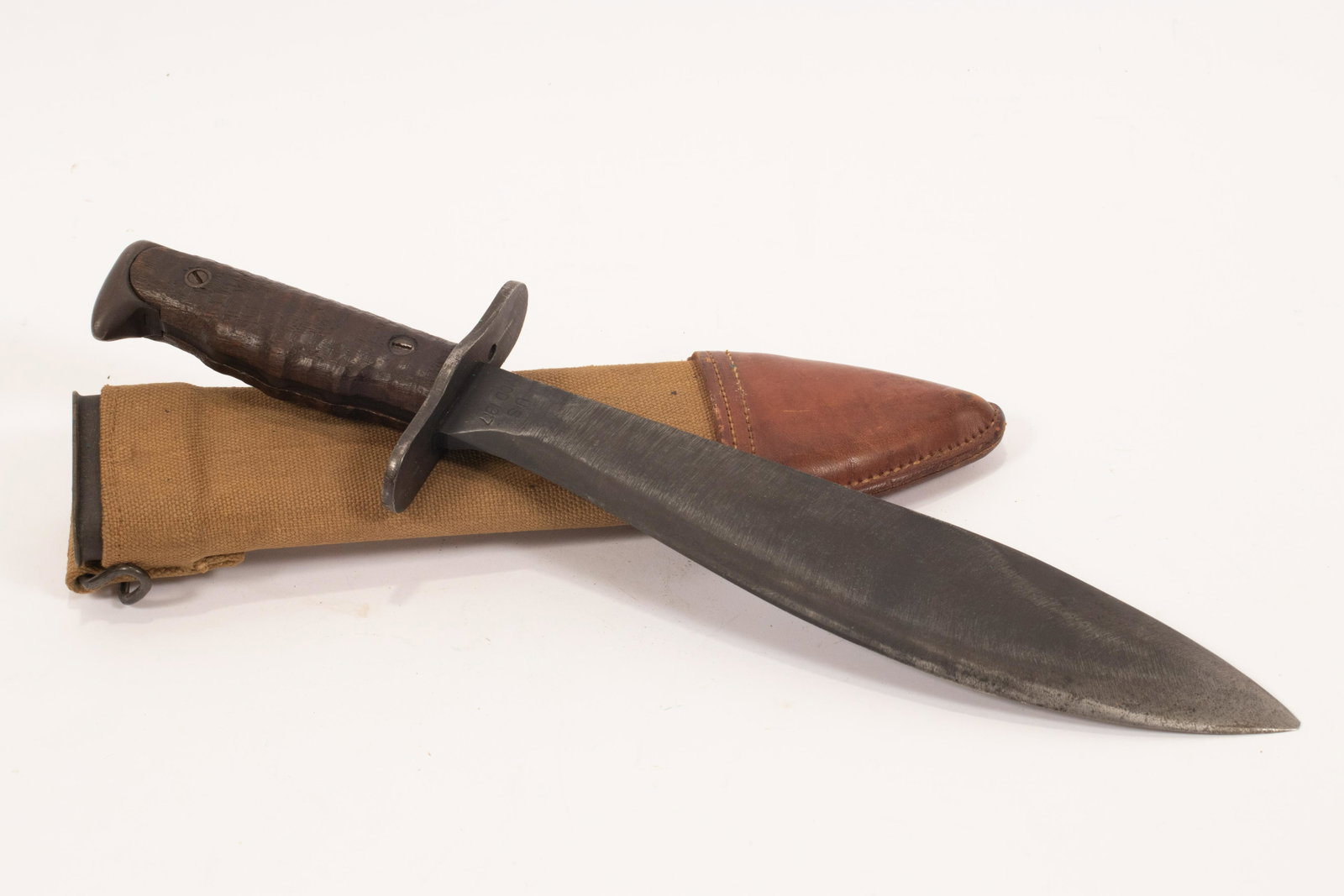 U.S. MODEL 1917 BOLO KNIFE AND SCABBARD, 1918, L 10: U.S. MODEL 1917 BOLO KNIFE AND SCABBARD, 1918, L 10 1/2" BLADE Manufactured in 1918 by Fayette Plumb Inc., Philadelphia PA. Ricasso is marked "Plumb Phila. 1918" and "US Mod 1917". Canvas and leather-