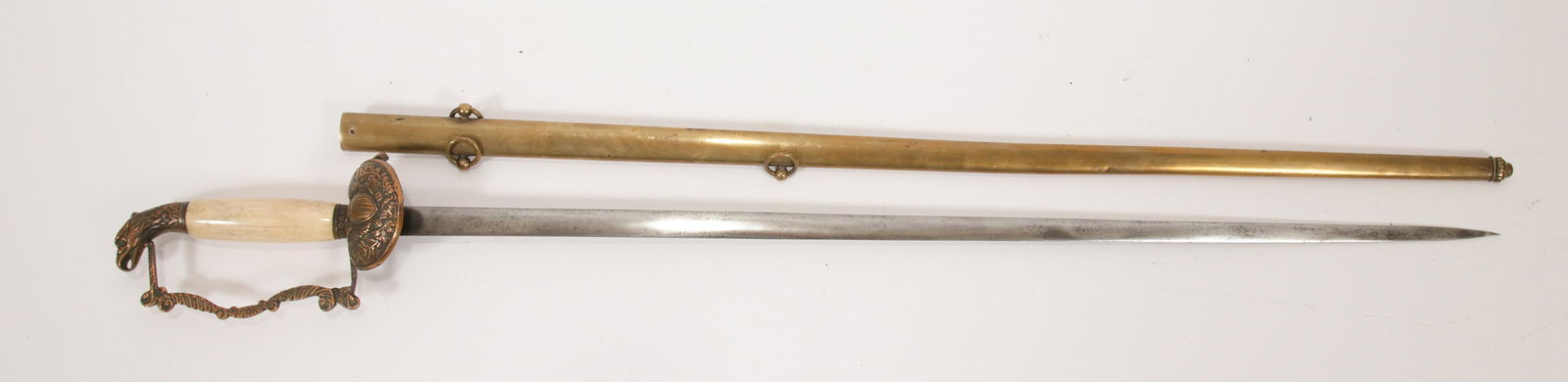 AMERICAN SWORD "FD" 1850 L 33 3/4" OVERALL: AMERICAN SWORD "FD" 1850 L 33 3/4" OVERALL Bone grip with eagle's head pommel. Clamshell guard with an eagle and crest. Undecorated blade. Includes brass scabbard. No apparent maker's mark. 28" blade.