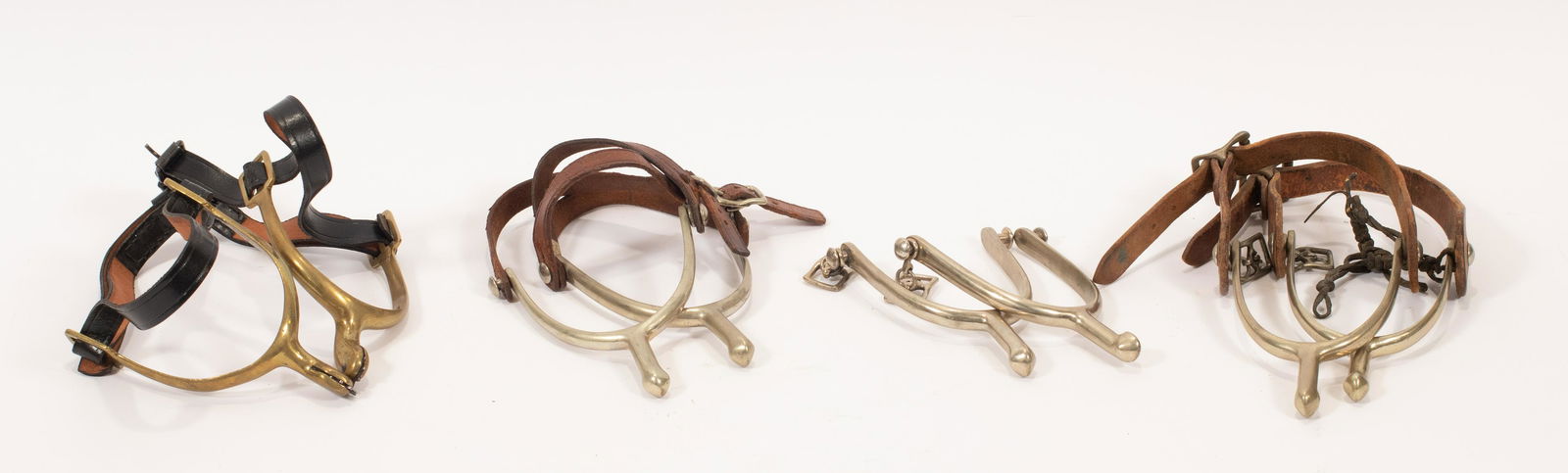 THREE PAIRS OF U.S. MODEL 1911 CAVALRY SPURS AND ONE: THREE PAIRS OF U.S. MODEL 1911 CAVALRY SPURS AND ONE PAIR OF MODEL 1885 CAVALRY SPURS, EARLY 20TH C., 8 PCS. TOTAL, H 5 1/2", W 3 1/2" One pair marked U.S. A.B., August Buermann, Buermann Manufacturin