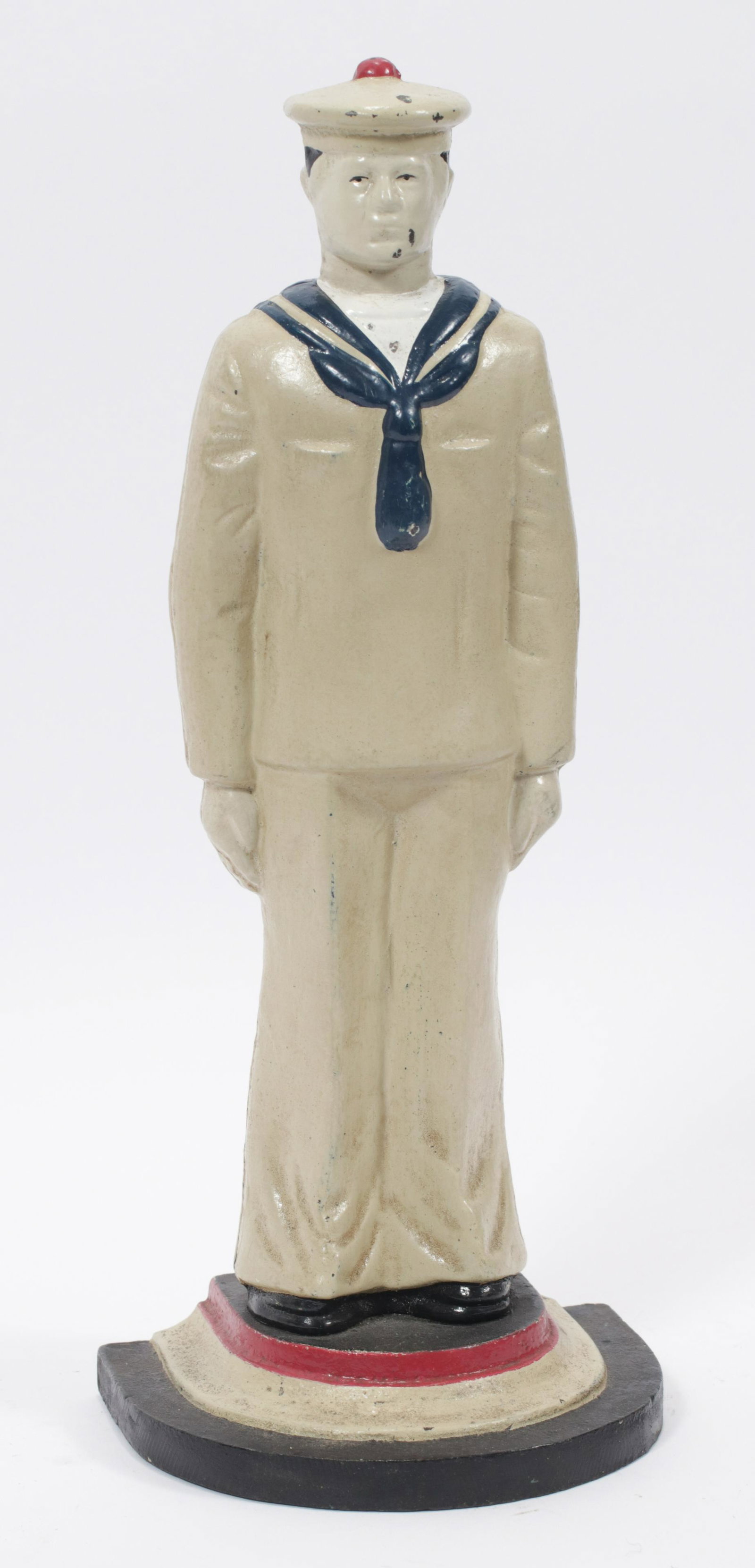 CAST IRON SAILOR DOORSTOP, C. 1930, H 13.5", W 5.5": CAST IRON SAILOR DOORSTOP, C. 1930, H 13.5", W 5.5" Depicting a Naval sailor at attention. Depth 4.25".
