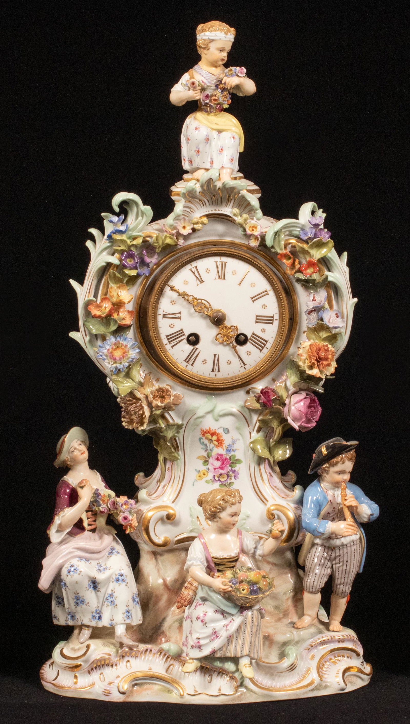 MEISSEN FIGURAL PORCELAIN MANTEL CLOCK, 19TH C, H 16",: MEISSEN FIGURAL PORCELAIN MANTEL CLOCK, 19TH C, H 16", W 8"The clock is modeled with three figures on shaped vase with a floral and musical motif. The shaped porcelain case surrounds the dial decorate