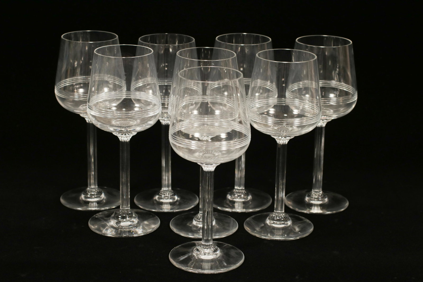 BACCARAT 'ATHENA' CRYSTAL WHITE WINES, 8 PCS, H 6.5": BACCARAT 'ATHENA' CRYSTAL WHITE WINES, 8 PCS, H 6.5" A set of eight Baccarat 'Athena' crystal white wine glasses. This pattern offers a ribbed stem and cut horizontal linear bands to the chalice. Each