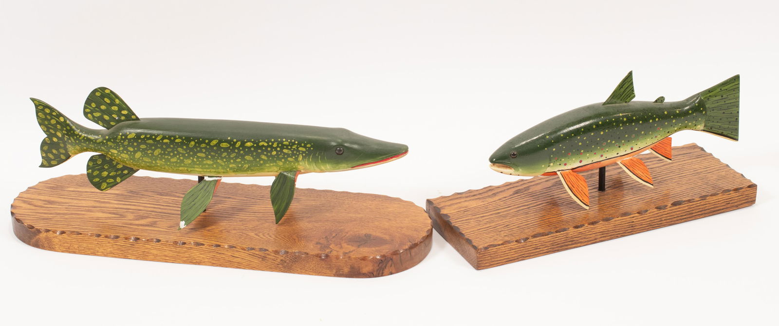 HAND CARVED TROUT AND PIKE L 14", 17": HAND CARVED TROUT AND PIKE L 14", 17" Fish are hand carved and hand-painted. Each is displayed on a rectangular wood stand. One fish is signed. From the Estate of Cheryl Powers Carey, Lincoln Rd. Gros