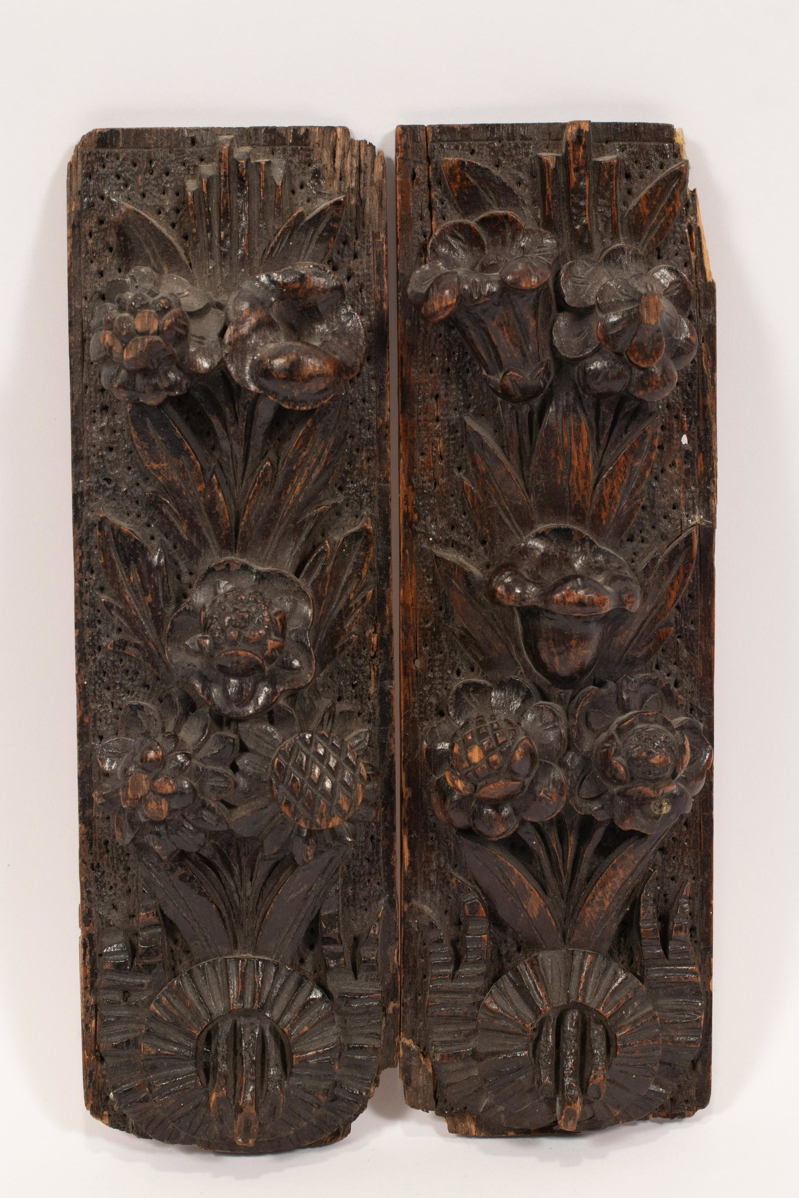 EUROPEAN/ENGLISH CARVED OAK WALL ORNAMENTS 18TH/19TH: EUROPEAN/ENGLISH CARVED OAK WALL ORNAMENTS 18TH/19TH C., PAIR H 12" W 4" Richly carved reliefs of floral sprays. With Christie's paper labels affixed verso. Provenance: Estate of Jack Faxon, Michigan 