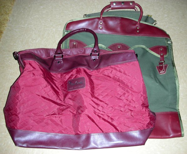 TRAVEL CASES TWO: PIERRE CARDIN, TIMBERDOODLE: TRAVEL CASES TWO: PIERRE CARDIN, AND TIMBERDOODLE:one Pierre Cardin 15" x 22", one Timberdoodle 26" x 22" canvas and leather. From the Collection of Alfred S. Warren.