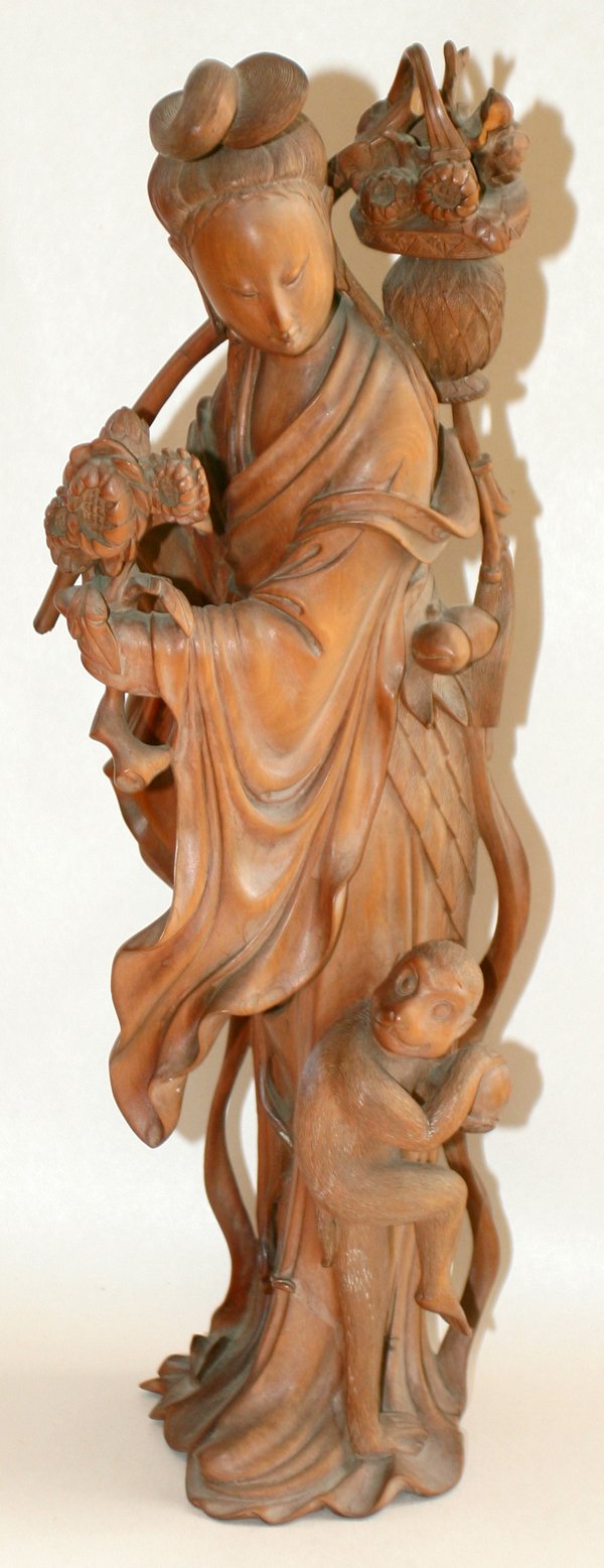 CHINESE CARVED WOOD QUAN YIN W/MONKEY, 19TH C.: CHINESE CARVED WOOD QUAN YIN WITH MONKEY, 19TH C., H 14":Finely carved quan yin holding lotus bloom with monkey at side. Single piece of wood. From the Estate of W. A. Warrick, Plymouth, Mi.