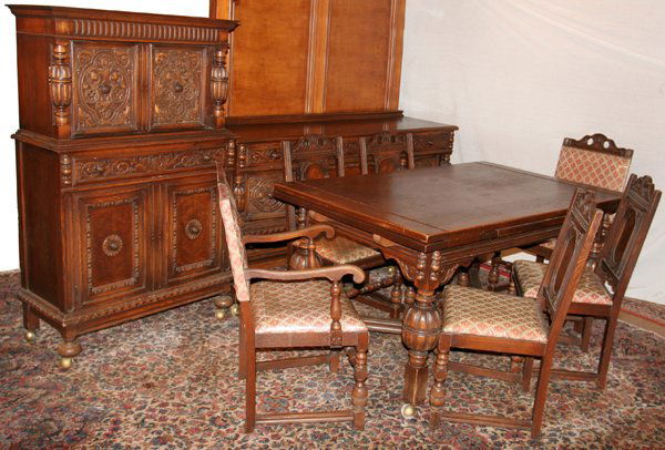 JACOBEAN STYLE, OAK DINING ROOM SUITE, NINE: JACOBEAN STYLE, OAK DINING ROOM SUITE, NINE PIECES:Including a refractory dining table, H 33 1/2", L 62", W 40" with two leaves, L 17"; a server, H 40", L 68", D 21" with four carved drawers with and