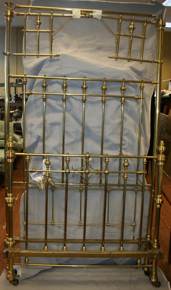 BRASS HIGH BACK TWIN BED, H 88", W 48": BRASS HIGH BACK TWIN BED, H 88", W 48":having a brass spindle design, with finials; 88" H. headboard; 48" H. footboard, both with casters; cast metal side rails and wood slats;