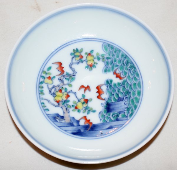 CHINESE PORCELAIN DISH, H 1 1/8", DIA 4 1/2": CHINESE PORCELAIN DISH, H 1 1/8", DIA 4 1/2":Featuring a light ground with peach trees and bats adorning both the interior and exterior.