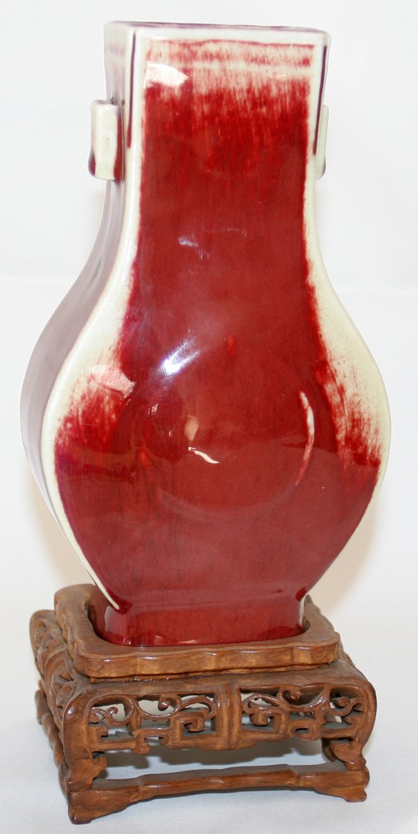 CHINESE SANG DE BOEUF VASE, 19TH C., H 7": CHINESE SANG DE BOEUF VASE, 19TH C., H 7":Baluster-form, on a teakwood stand.