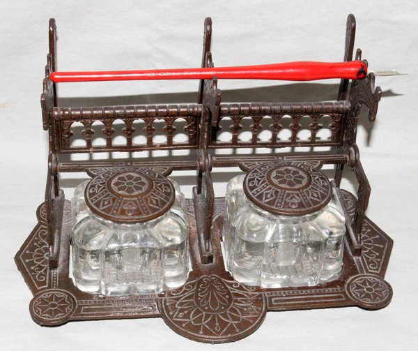 VICTORIAN IRON INKSTAND, H 5", L 8": VICTORIAN IRON INKSTAND, H 5", L 8":Two crystal inkpots. Circa 1870. Hinged iron covers.