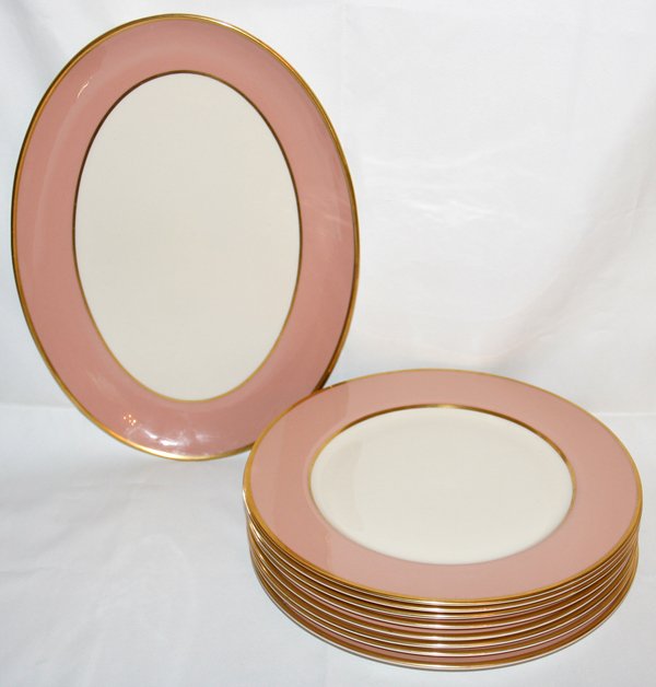 FLINTRIDGE PORCELAIN PLATTER & PLATES (9),: FLINTRIDGE PORCELAIN PLATTER & PLATES (9), DIA 10":Including 1 oval platter, L.13" x 10", and a set of 9 plates, Dia.10 1/2"; each piece is bordered in salmon pink flanked by gold bands. Nine pieces t