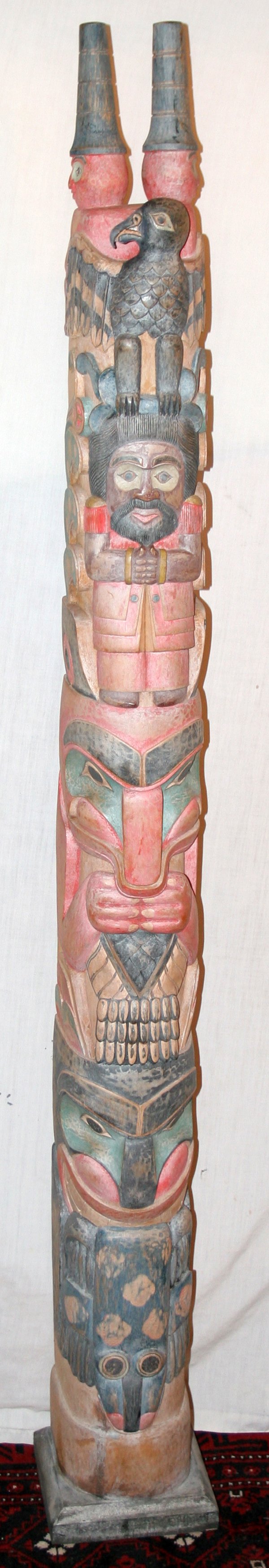 HAIDA STYLE CARVED POLYCHROMED WOOD TOTEM POLE,: HAIDA STYLE CARVED POLYCHROMED WOOD TOTEM POLE, AFTER 1960, H 70", W 8", D 8":Eagle at top with 2 watchmen above; unsigned.