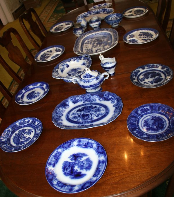 FLO BLUE CHINA GROUPING 20 PCS.: FLO BLUE CHINA GROUPING 20 PCS.:Includes 9 plates, Dia 9" to 10 1/2"; 4 platters, L 10 1/2" to 18"; compote, L 12"; pedestal bowl, Dia. 7"; 3 creamers; 2 sugars.