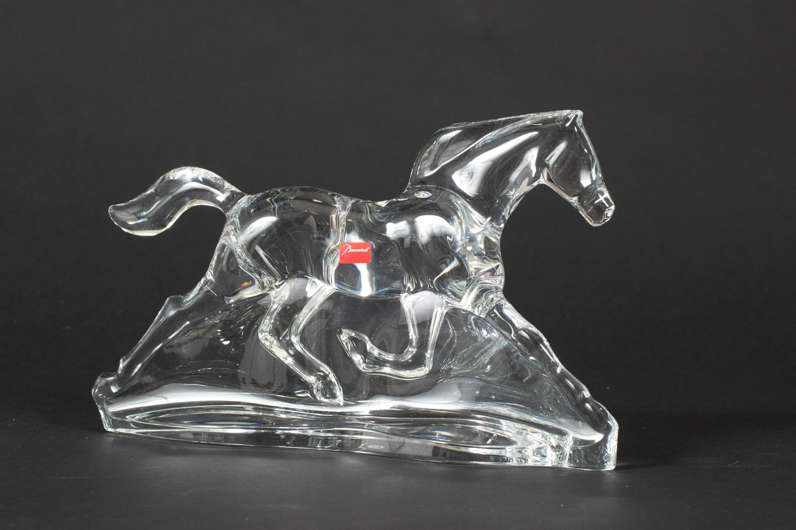 BACCARAT APOLLON CRYSTAL HORSE FIGURE H 7.25", W 12", D: BACCARAT APOLLON CRYSTAL HORSE FIGURE H 7.25", W 12", D 3"Signed. Imitates movement and elegance of powerful horse. With box. Provenance: A Grosse Pointe Shores, MI estate.
