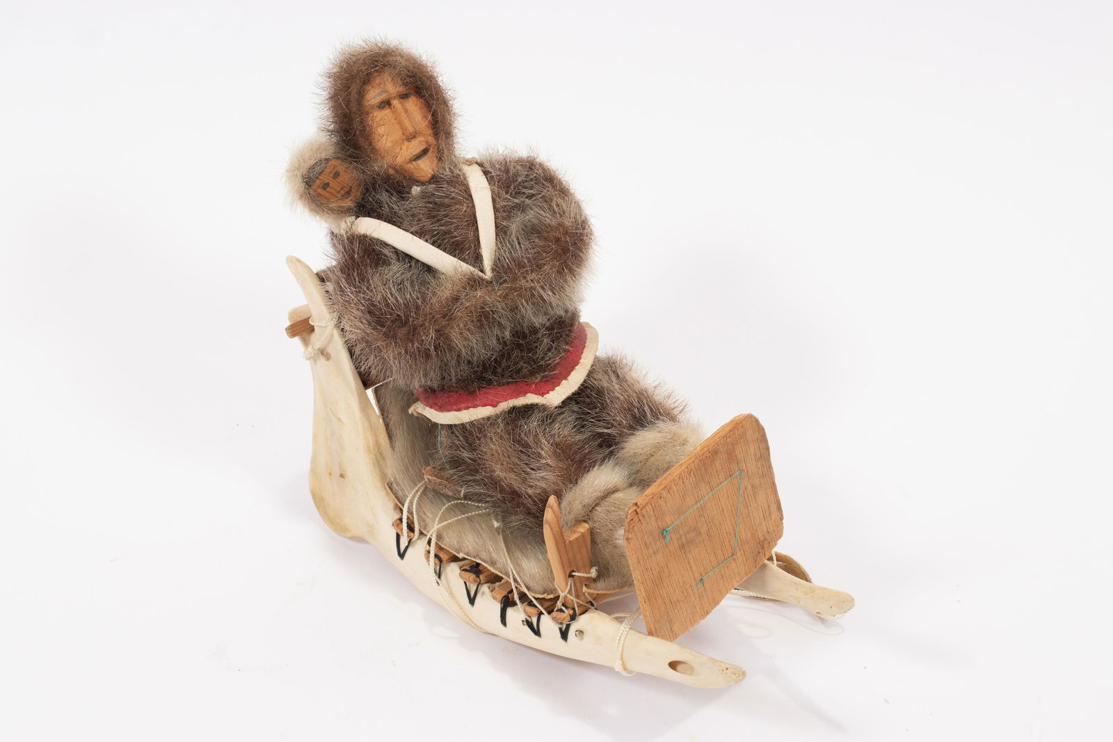 INUIT  FUR CLAD  DOLL AND JAWBONE SLED C. 1960 H 9.5" L (1 of 3)