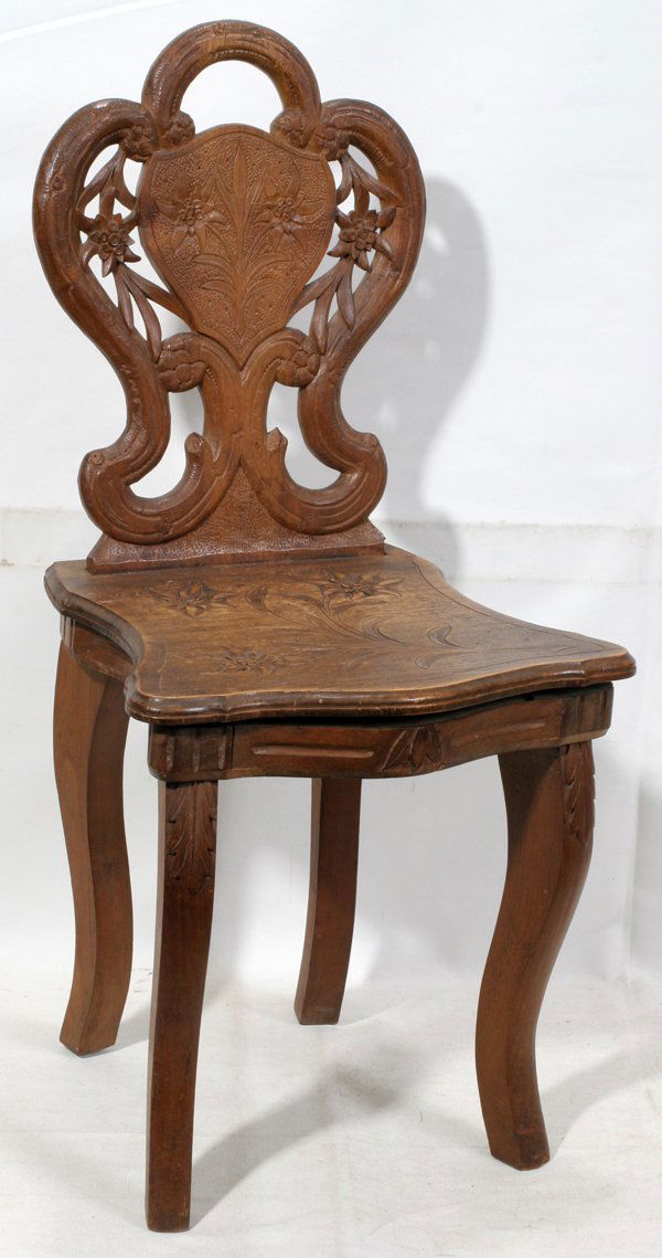 SWISS WALNUT MUSICAL CHILD'S CHAIR C1920, H 25": SWISS WALNUT MUSICAL CHILD'S CHAIR, C1920, H 25", W 12":With floral motifs at the back splat and the seat. The chair has hinges at the back, but it has been altered and they no longer access the music