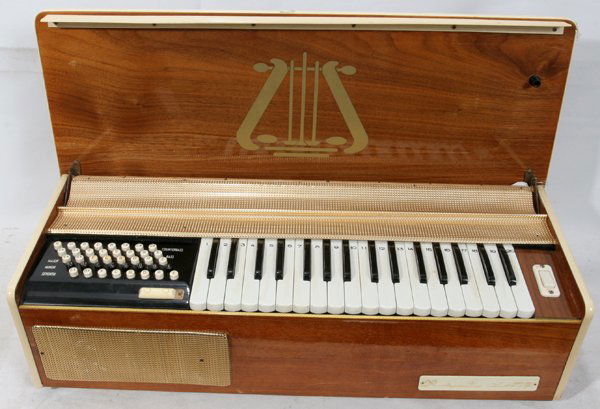 ACCORDION BASE ORGAN 33085, ART DECO, CELLULOID: ACCORDION BASE ORGAN 33085, ART DECO, CELLULOID & BAKELITE, ELECTRIC, H 8", W 27", D 10":runs on bellows.