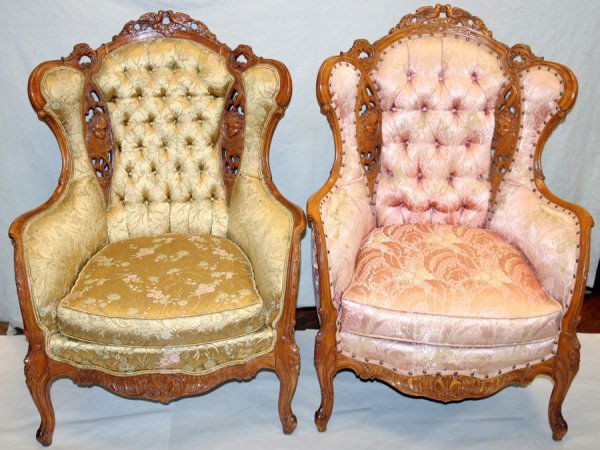 VICTORIAN STYLE CARVED WALNUT WING BACK CHAIRS: VICTORIAN STYLE CARVED WALNUT WING BACK CHAIRS, PAIR, H 43", W 32", D 32":Featuring pierced carved figures of birds and children. One is pink floral upholstered while the other has yellow floral uphol
