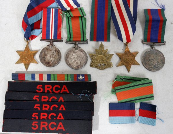 BRITISH & CANADIAN, WW II MEDALS & RIBBONS 6+: BRITISH AND CANADIAN, WW II MEDALS AND RIBBONS 6+:6 medals, numerous ribbons. 1. The British War medal, 1939 - 45 with the Crowned head of King George VI and British Lion on verso; 2. The King George 