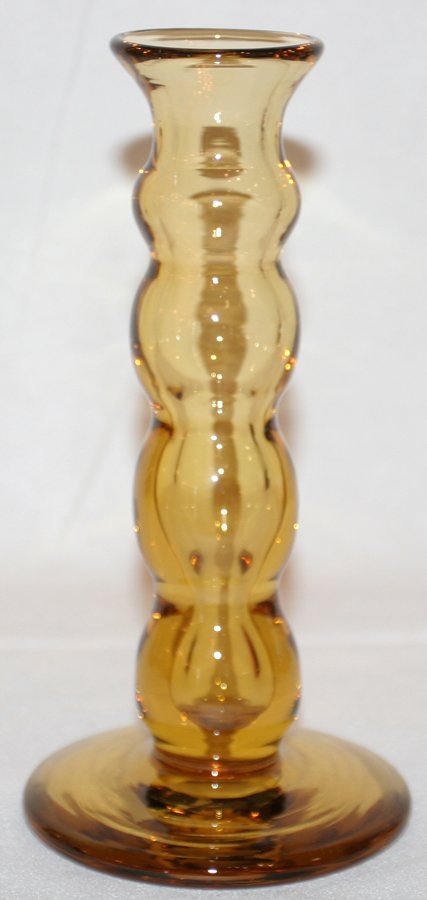 DOMINICK LABINO AMBER GLASS CANDLESTICK: DOMINICK LABINO (1910-87) AMBER GLASS CANDLESTICK, 1976, H 7 1/2":Signed "Labino 5-1976" at the underside (see additional photo). Polished pontel. From the collection of Helen W. Korman of Toledo, Ohi