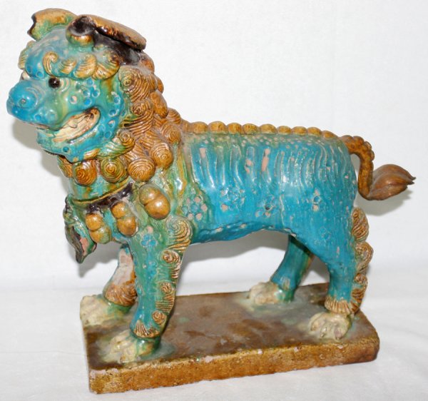 CHINESE GLAZED POTTERY FU DOG, H 13": CHINESE GLAZED POTTERY FU DOG, H 13":A standing figure on a rectangular base, glazed in turquoise and brown. Measures H.12 3/4" x 11". From the Estate of David Steinman, Bloomfield Hills, Michigan.