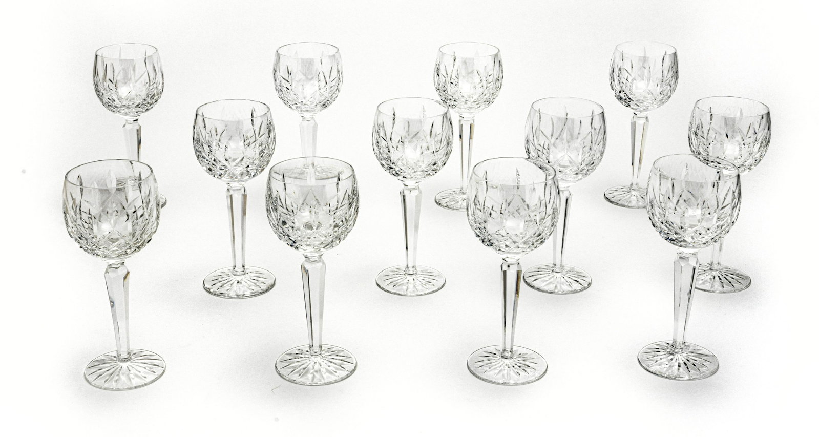 WATERFORD 'LISMORE' CRYSTAL WINE GOBLETS: WATERFORD 'LISMORE' CRYSTAL WINE GOBLETS, 12 PCS, H 7.5", DIA 3" A collection of twelve Waterford 'Lismore' crystal wine goblets. Each having acid etched branding to the undersides.