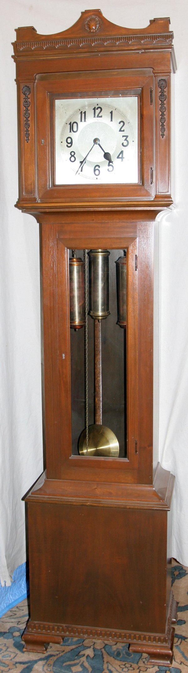 GERMAN MAHOGANY TALL CASE CLOCK, H 84": GERMAN MAHOGANY TALL CASE CLOCK, H 84":With three weights; made in Germany. Mid 20th century.
