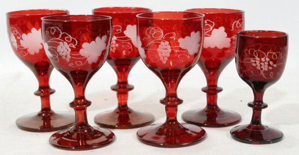 BOHEMIAN FLASHED RUBY STEMWARE, 6 PIECES, H 4": BOHEMIAN FLASHED RUBY STEMWARE, SIX PIECES, H 4":Including a set of 5 wines, H.4 1/2", and 1 other wine, H.3 1/2"; each etched about the bowl with a grapevine motif.