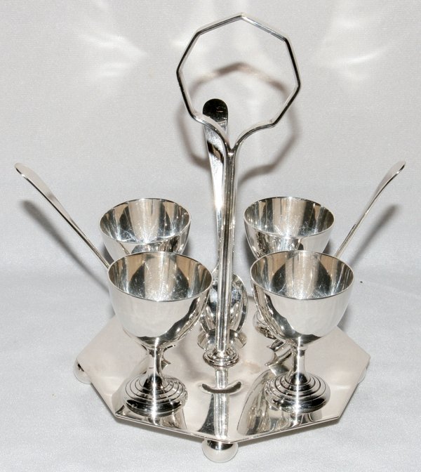 SHEFFIELD SILVER PLATE EGG SET, H 8", W 5": SHEFFIELD SILVER PLATE EGG SET, H 8", W 5":Including four egg cups and three spoons on a stand.