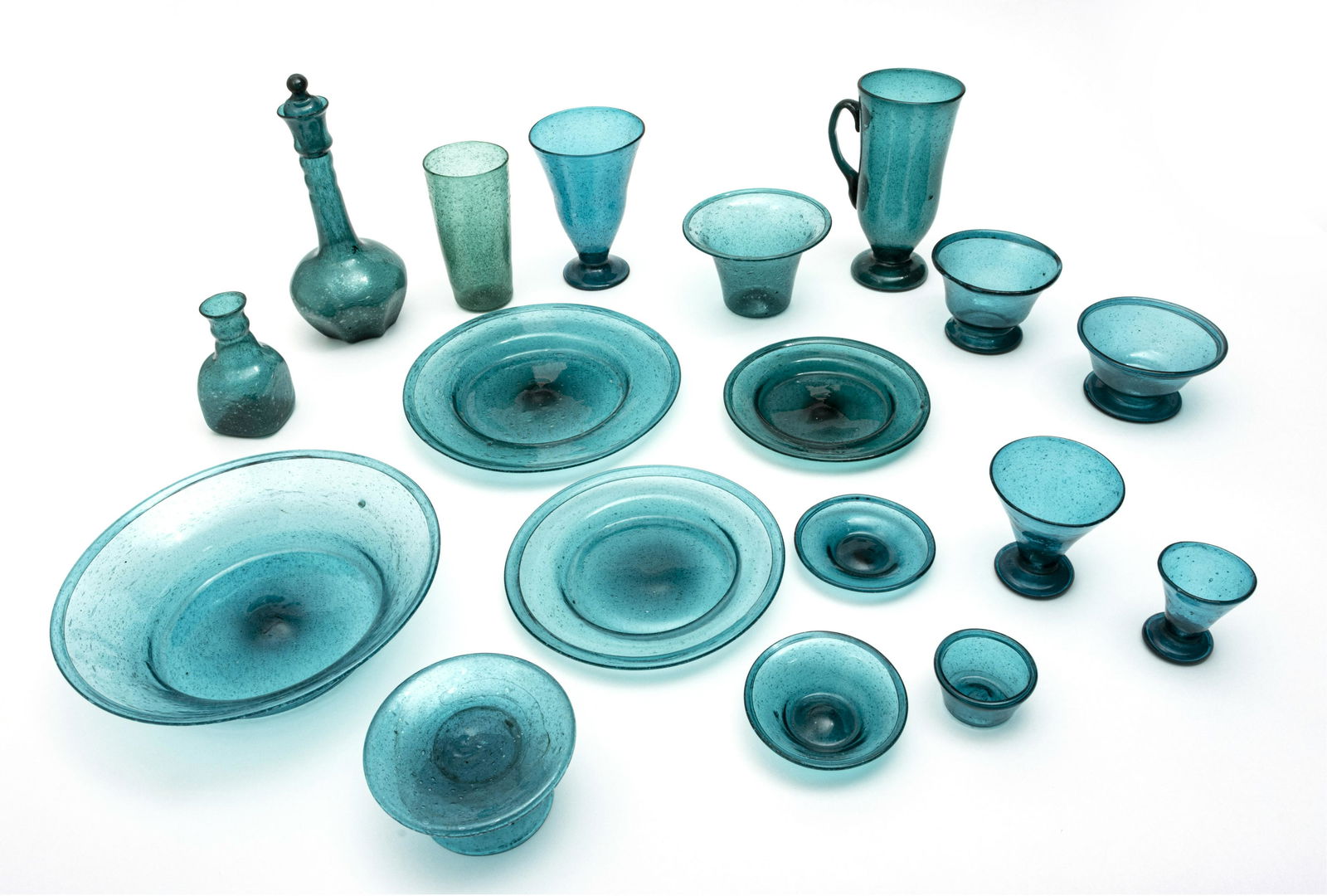 EGYPTIAN HAND BLOWN GREEN STEMWARE AND TABLEWARE: EGYPTIAN HAND BLOWN GREEN STEMWARE AND TABLEWARE 176 PCS. 16 goblets pedestal base 6.5"; 16 dinner plates 9.5"; 20 cup plates @ 4"; 38plates approx 7"- 8", 6 cone shape tumblers 6"; 15 small bowls 4"