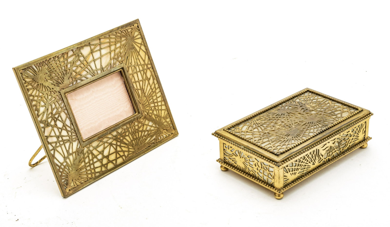 TIFFANY STUDIOS, NEW YORK, BRONZE AND GLASS FRAME: TIFFANY STUDIOS, NEW YORK, BRONZE AND SLAG GLASS PICTURE FRAME AND BOX, TWO PCS. The picture frame having a height of 6" and width of 7 1/4" with a 2 1/2" X 3 1/2" area for a picture. Marked on the ba