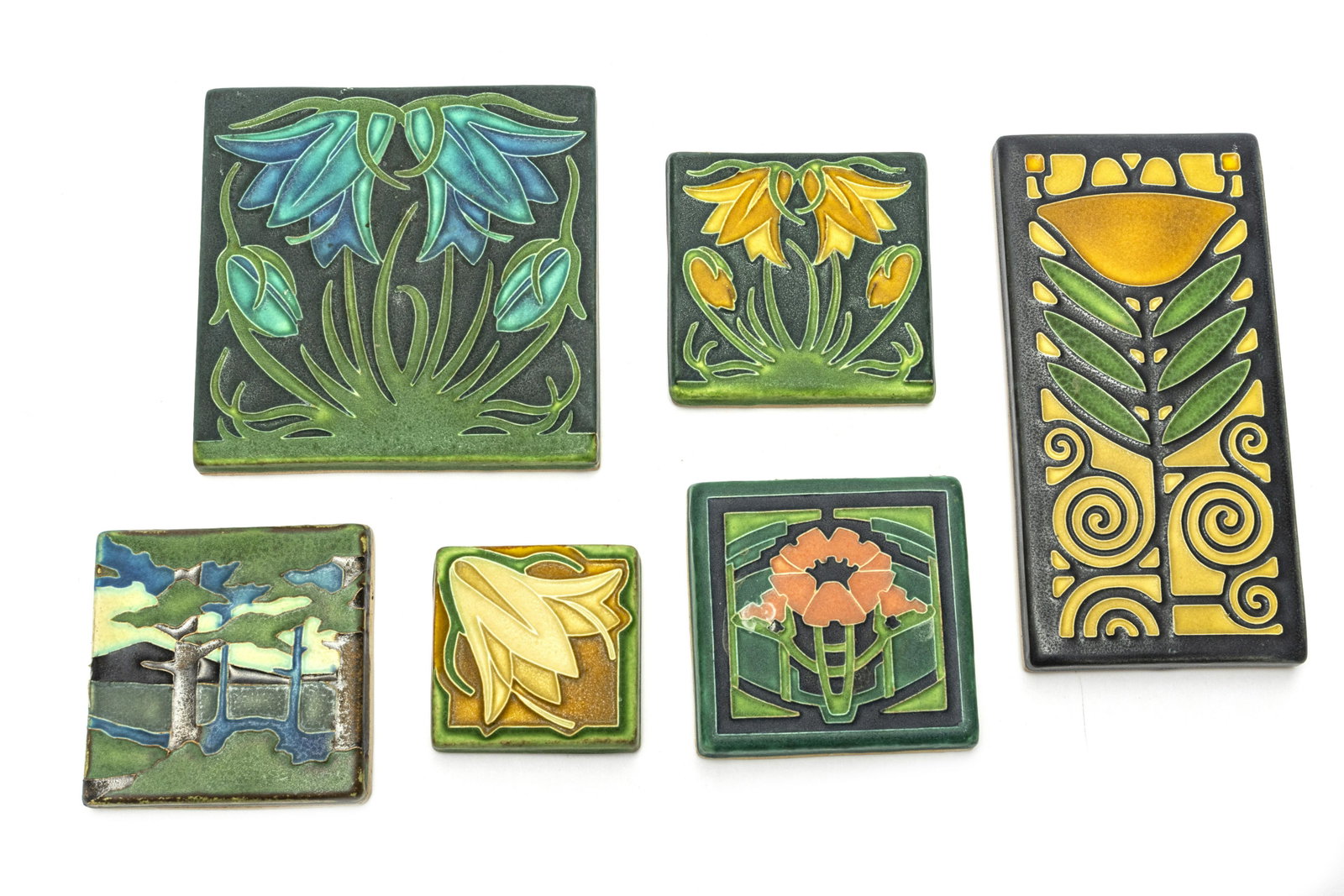 MOTAWI TILEWORKS CERAMIC TILES, 6 PCS, H 3"-8": MOTAWI TILEWORKS CERAMIC TILES, 6 PCS, H 3"-8"A collection of six Motawi Tileworks (Ann Arbor) ceramic tiles. Included are the 'Dard Hunter Poppy' and the 'Pine Landscape - Mountain' tiles. Each brand