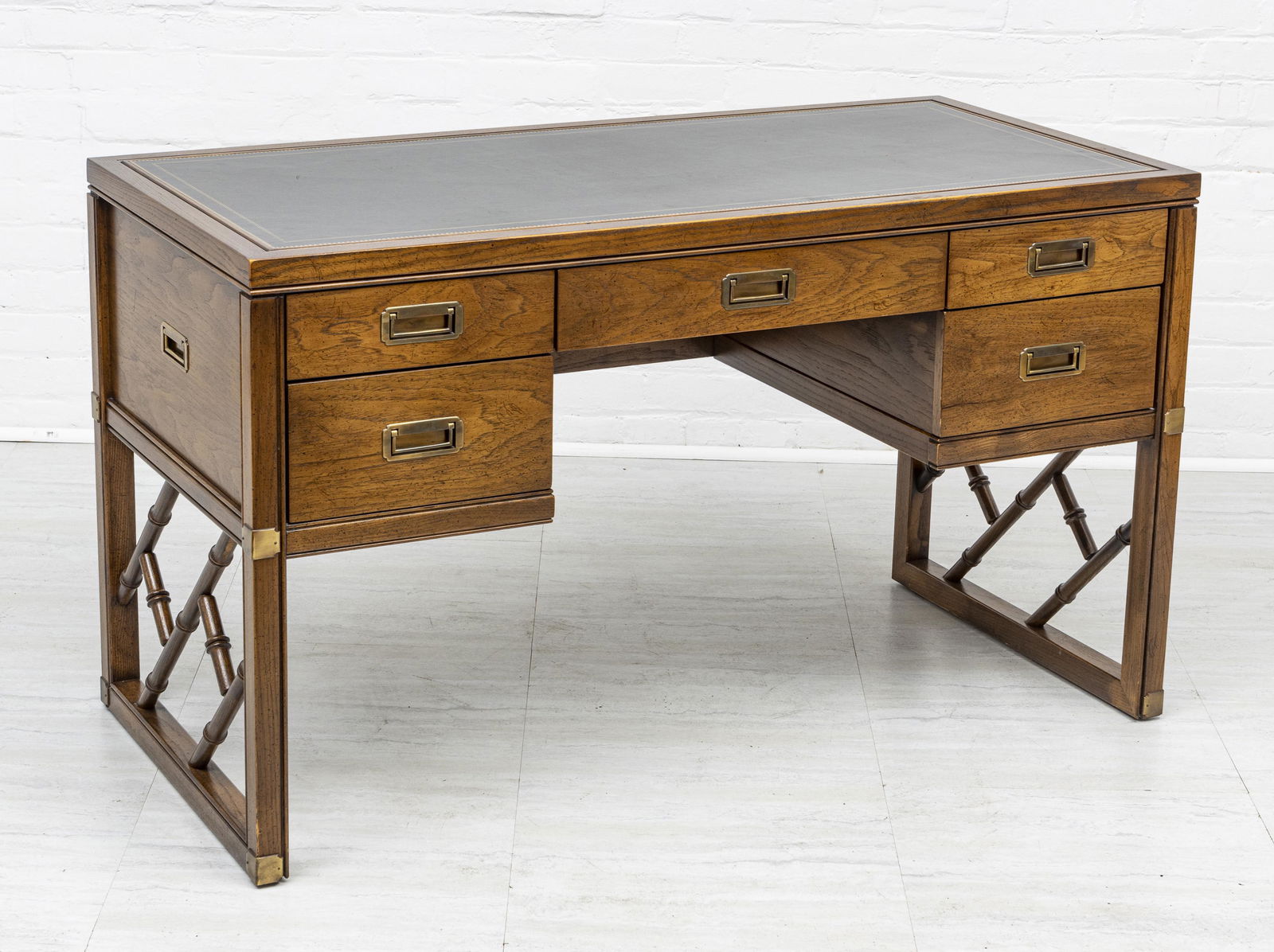 SLIGH CAMPAIGN STYLE, TOOLED LEATHER TOP DESK: SLIGH CAMPAIGN STYLE, TOOLED BLACK LEATHER TOP DESK H 29" L 50" Walnut, with five drawers. D 24". From the estate of Lois Jacobs, Grosse Pointe Shores.