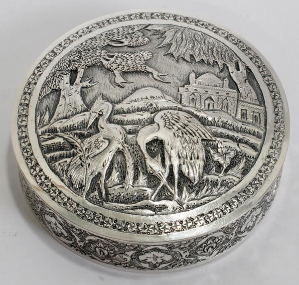 MIDDLE EASTERN SILVER BOX, PROBABLY PERSIAN, : MIDDLE EASTERN SILVER BOX, PROBABLY PERSIAN, H 1", DIA 3":Small round box is decorated with an exterior scene on the top with birds and a mosque, in the background. The sides are decorated with floral