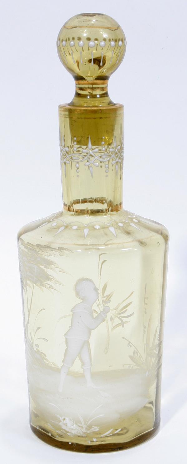 MARY GREGORY GLASS COLOGNE BOTTLE 19TH C., H 8": MARY GREGORY GLASS COLOGNE BOTTLE, 19TH C., H 8":Hand-blown glass bottle, light yellow color with white enamel decoration of a boy in a landscape, gilt accents. Matching etched number at the base of t