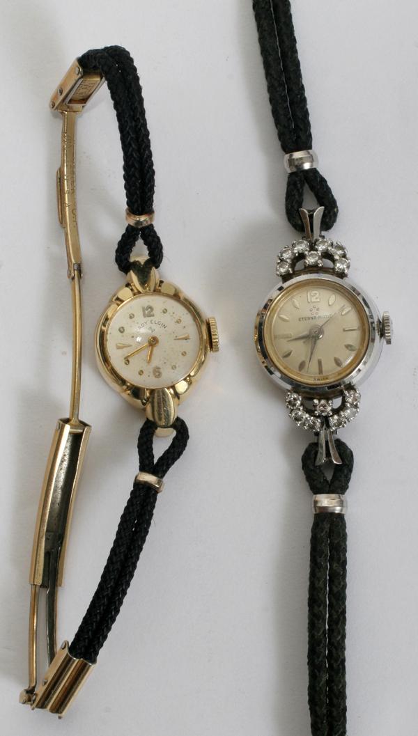 14KT LADY'S WRIST WATCHES: ELGIN & ETERNA MATIC: 14KT LADY'S WRIST WATCHES: ELGIN & ETERNA MATIC:Eterna Matic watch enhanced with 14 small diamonds, 14kt white gold with a black elastic band. Lady Elgin is 14kt yellow gold with elastic band. Propert