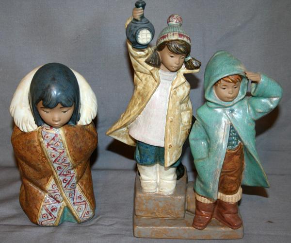 LLADRO PORCELAIN FIGURES, 2, H 7 1/2" & 10 1/4": LLADRO PORCELAIN FIGURES, TWO, H 7 1/2" & 10 1/4":Including 1 "Artic Winter" figure which depicts an Inuit girl wrapped in a coat with a fur collar together with 1 figural group of a boy and girl, hol