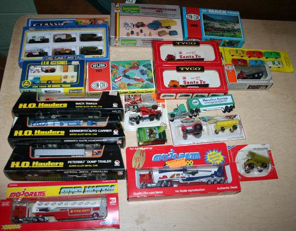 TYCO, MAJORETTE, HO HAULERS, ETC. 20 PCS.: TYCO, MAJORETTE, HO HAULERS, ETC. 'HO' SCALE VEHICLES 20 PCS.:includes cars, trucks, Helicopter on flatbed, fire engine ladder truck, etc. in boxes;