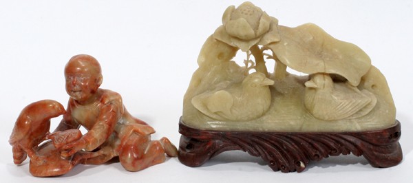 ORIENTAL SOAPSTONE & HARD STONE FIGURES, TWO: ORIENTAL SOAPSTONE & HARD STONE FIGURES, TWO:The soapstone figure features two birds at rest under leaves and a flower H 2 3/4", L 4" and the second figure is a boy feeding a hawk H 1 1/2", L 3".