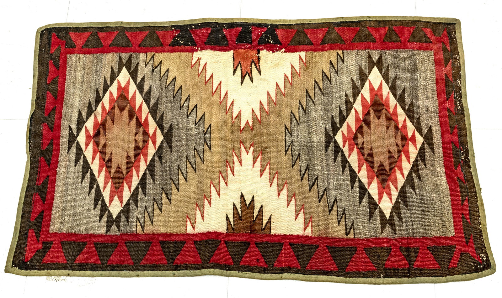 NAVAJO WOOL BLANKET, EARLY TO MID 20TH C: NAVAJO WOOL BLANKET, EARLY TO MID 20TH C., W 2' 2 1/2", L 3' 6 1/2" Having a tan ground with red, grey, brown and black diamond patterning. Provence: property of a Ortonville, MI estate.