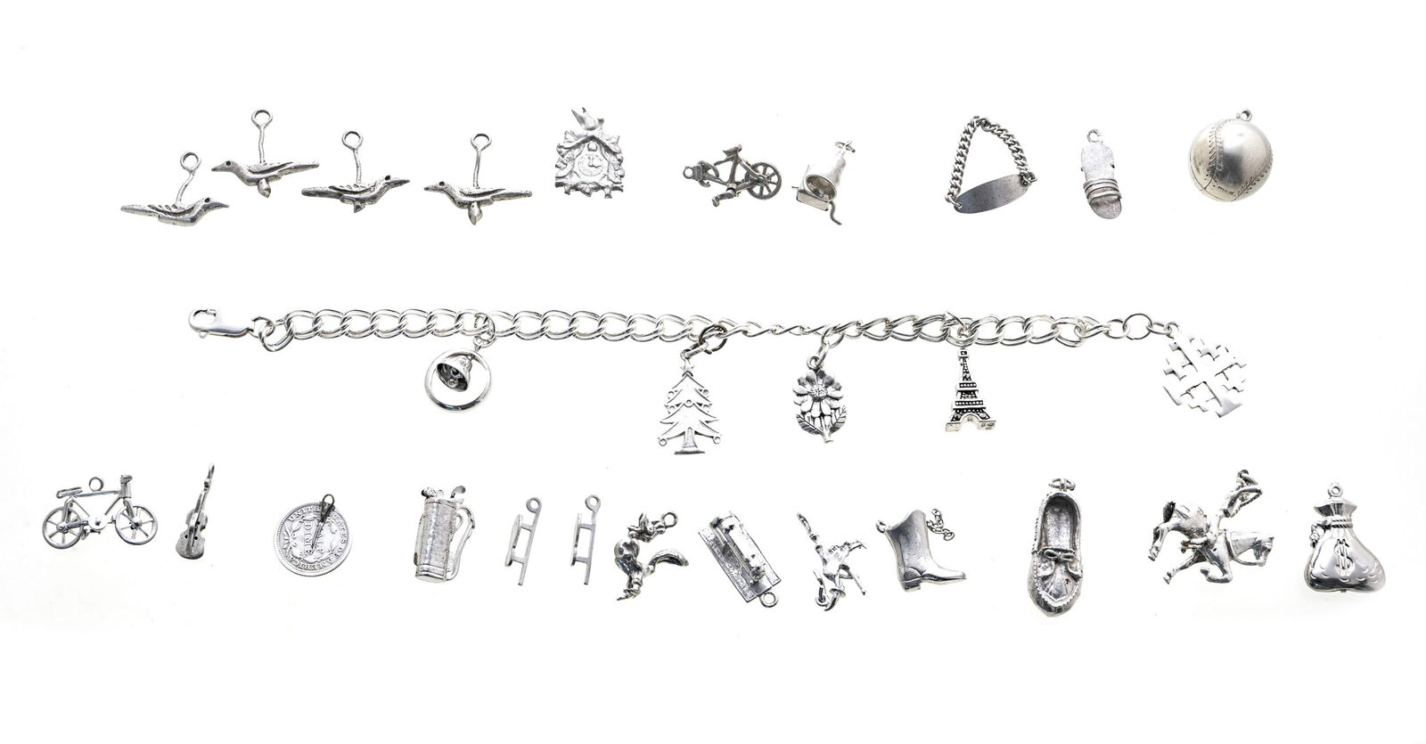 STERLING CHARM BRACELET, UNATTACHED CHARMS: STERLING CHARM BRACELET, UNATTACHED CHARMS One Sterling vintage charm bracelet 7 1/2" with five charms attached. Fourteen + unattached charms (bicycle, rooster, money bag, witch, victrola, horseback r