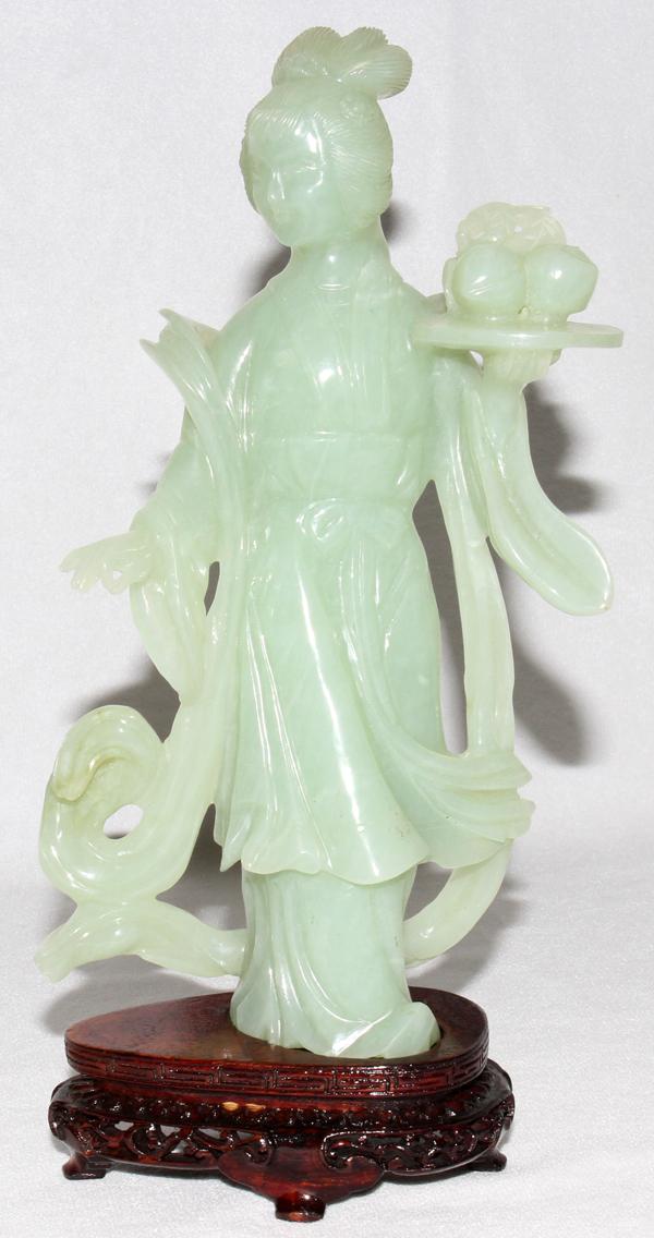 CHINESE CARVED JADEITE FIGURE, H 8": CHINESE CARVED JADEITE FIGURE, H 8":Carved figure is in traditional dress and holds a tray full of fruit in her left hand. Includes a separate wood base and a fitted case.