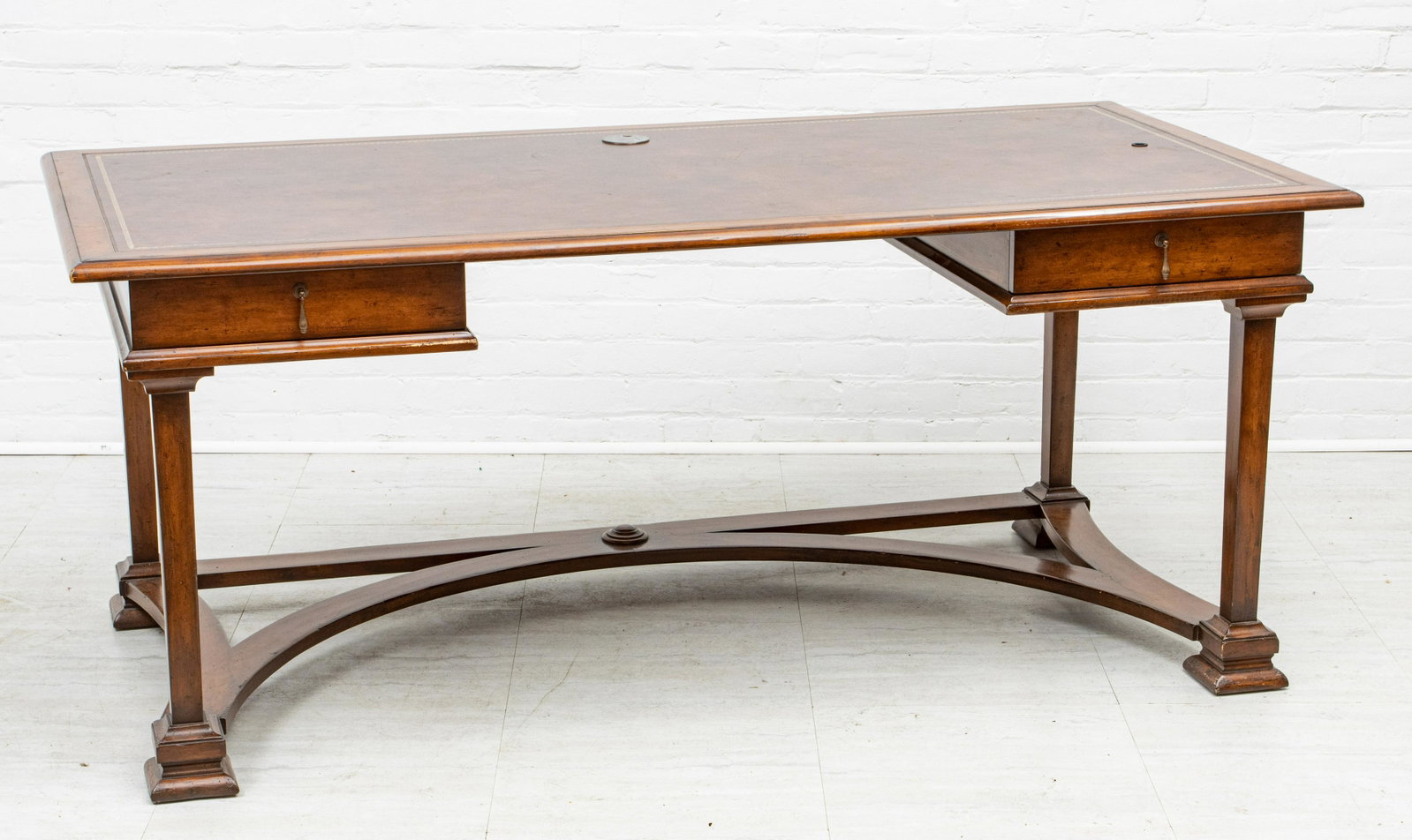 MAHOGANY & TOOLED LEATHER DESK, H 30", W 72", D 36": MAHOGANY & TOOLED LEATHER DESK, H 30", W 72", D 36" A mahogany desk with a tooled leather surface. Offers two drawers and four feet with curved stretcher.