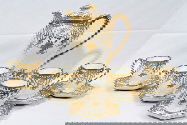 NIPPON PORCELAIN DEMITASSE SET: NIPPON PORCELAIN DEMITASSE SET:Chocolate set, including 6 cups & saucers and a chocolate pot, H 10" all having hexagonal shapes. Fired gold trim;
