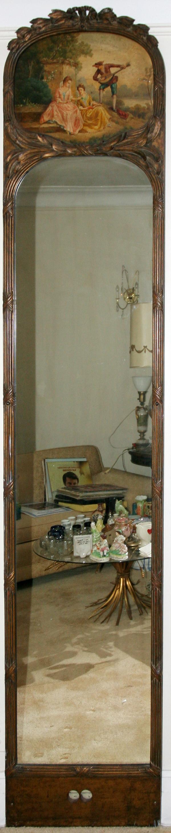 GILT MAHOGANY PIER MIRROR, C. 1920'S, H 102", : ANTIQUE STYLE GILT MAHOGANY PIER MIRROR, C. 1920'S, H 102", W 20":Painted courting scene at the top surrounded by a carved gilt wood frame which traverses to a panel at the bottom of the mirror;